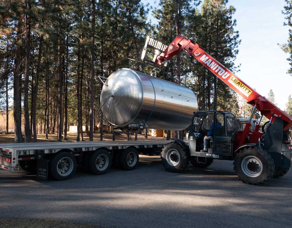 Biron Construction new tank being lifted off flatbed for Soma Cidery
